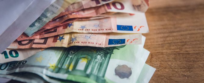 euro banknote collection on wooden surface
