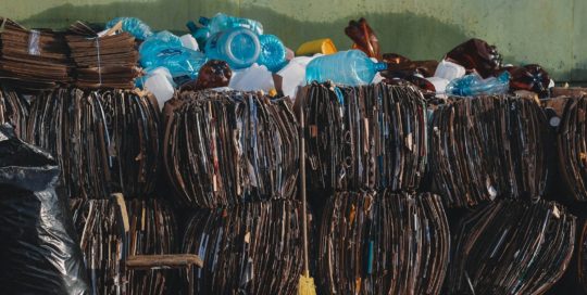 a pile of trash sitting next to a green wall